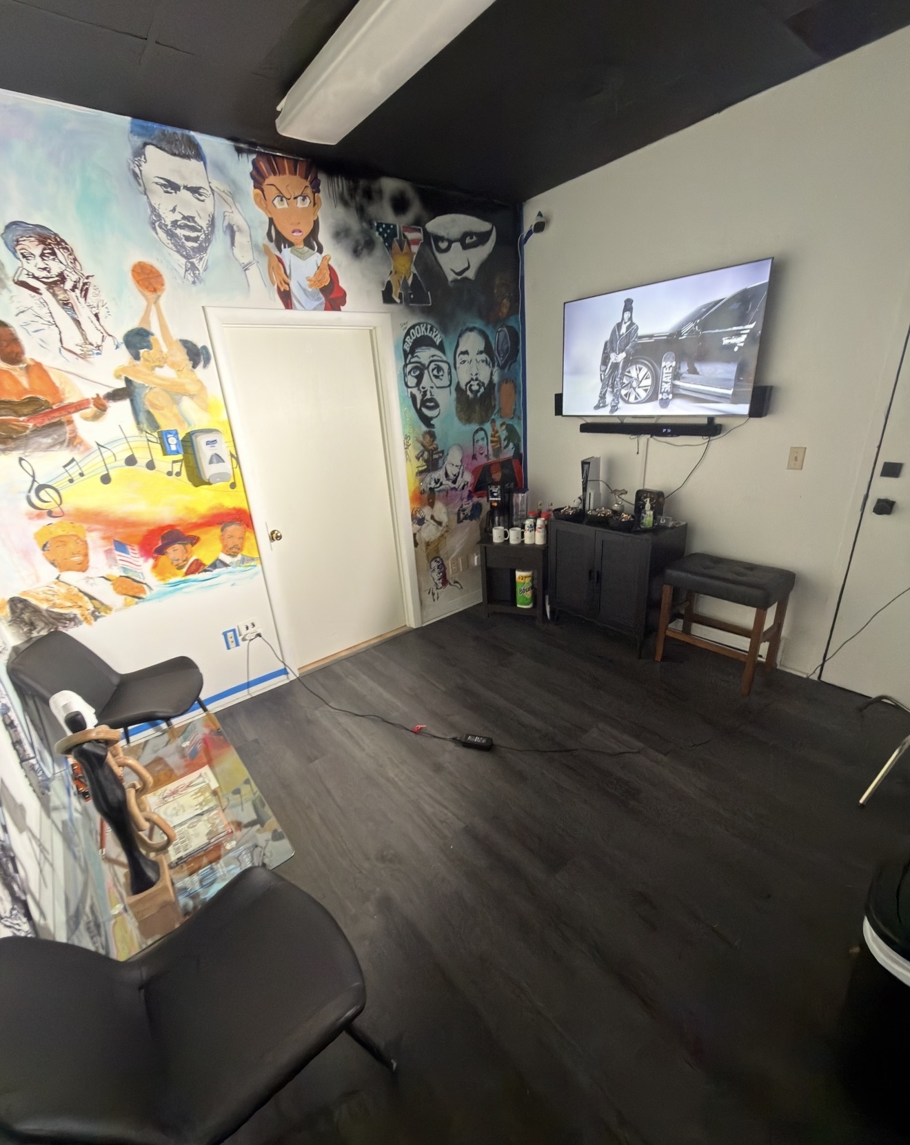 The Sanctuary lounge — mural by Rouse of New Haven, screening TV, and seating