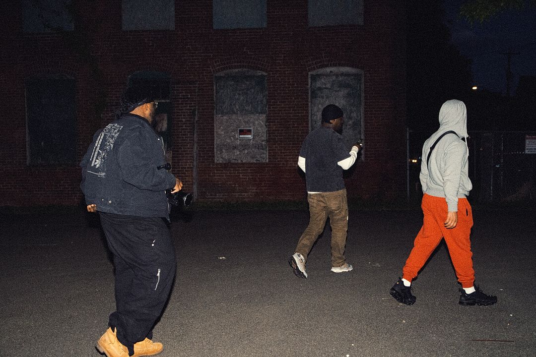 Tell Ours crew walking at night with a camera
